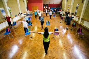 StayActive4Life class members doing an arm-stretch exercise